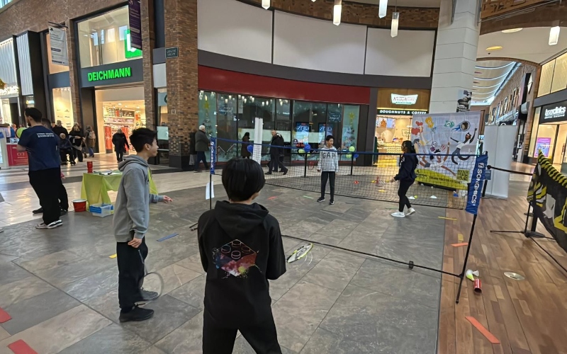 Badminton is played with a pop up net in the middle of a shopping centre