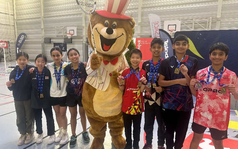 Team England pose with a mascot and their medal haul